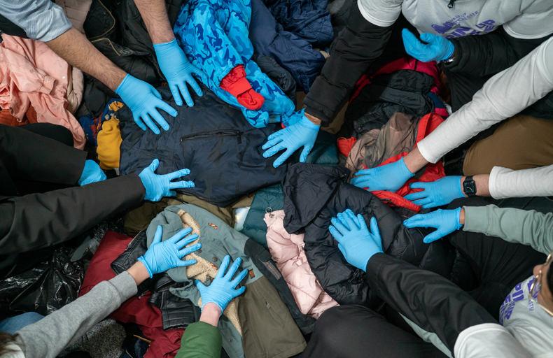 Volunteers collecting and sorting winter coats for families in need
