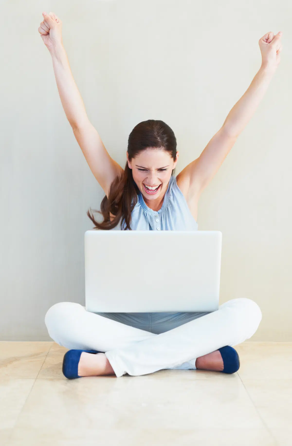 Person with laptop celebrating — completed benefits enrollment process