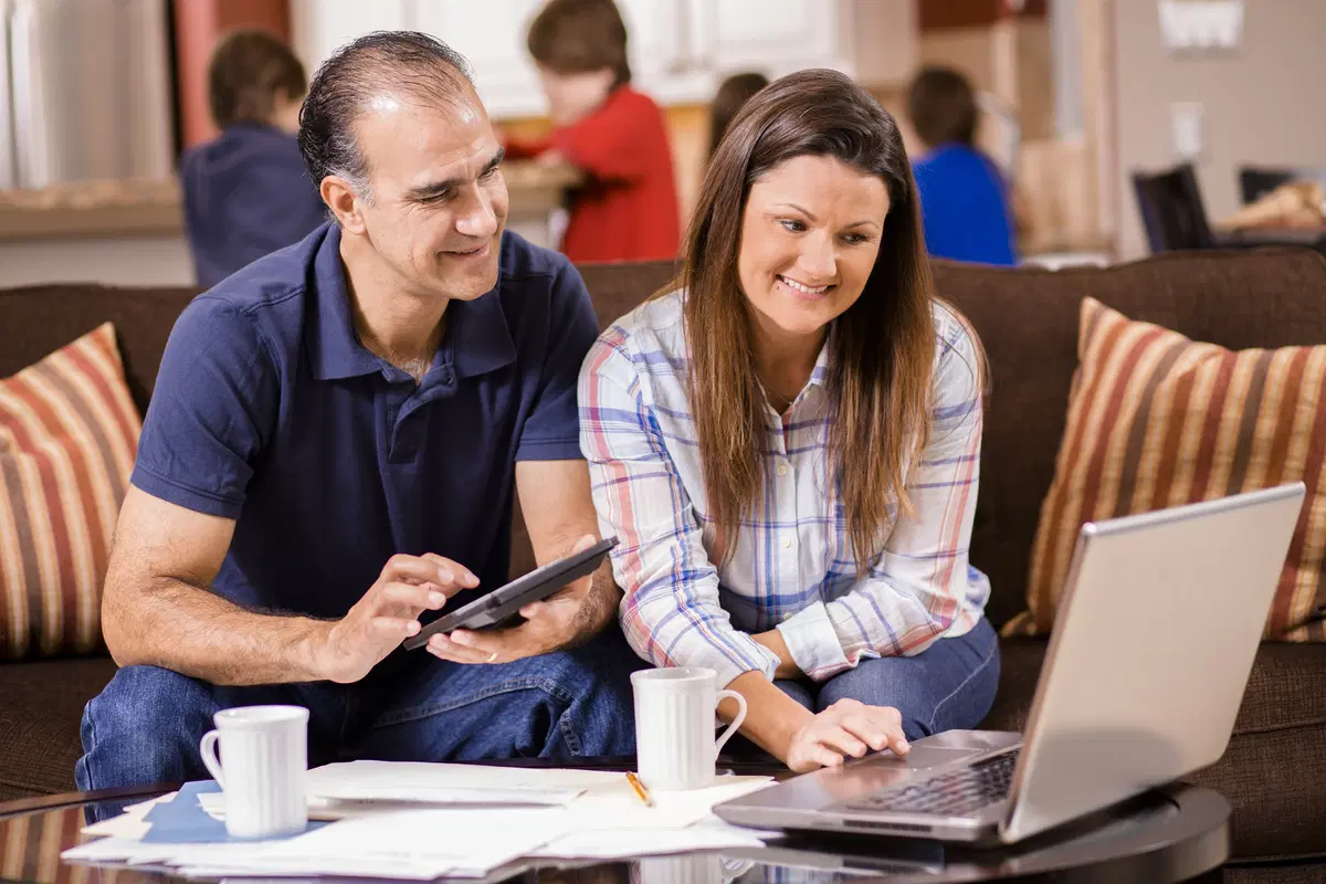 Couple working together at computer — joint benefits enrollment review and selection