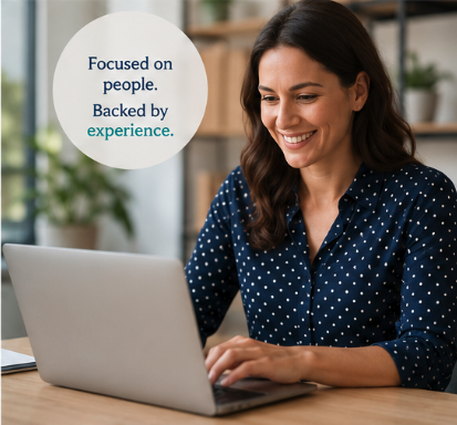 Smiling professional working on a laptop beside the words 'Backed by experience,' representing BAS's HRA administration support
