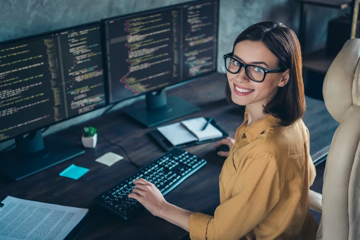 Woman working on software code — benefits platform security and software development